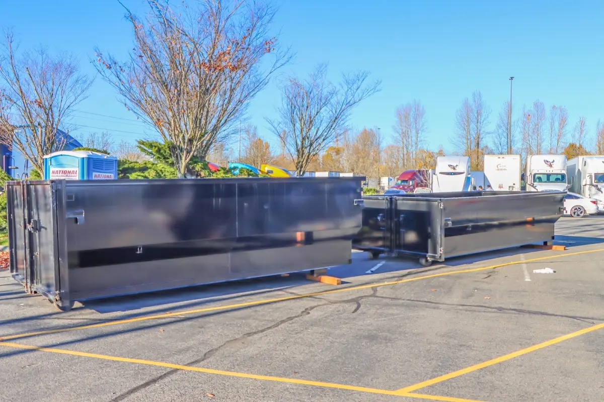 Professional dumpster rental service with roll-off container on residential driveway in Anamosa